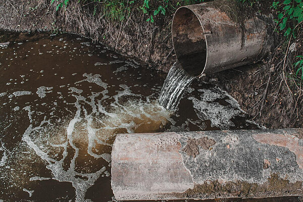 drains emptying into a river